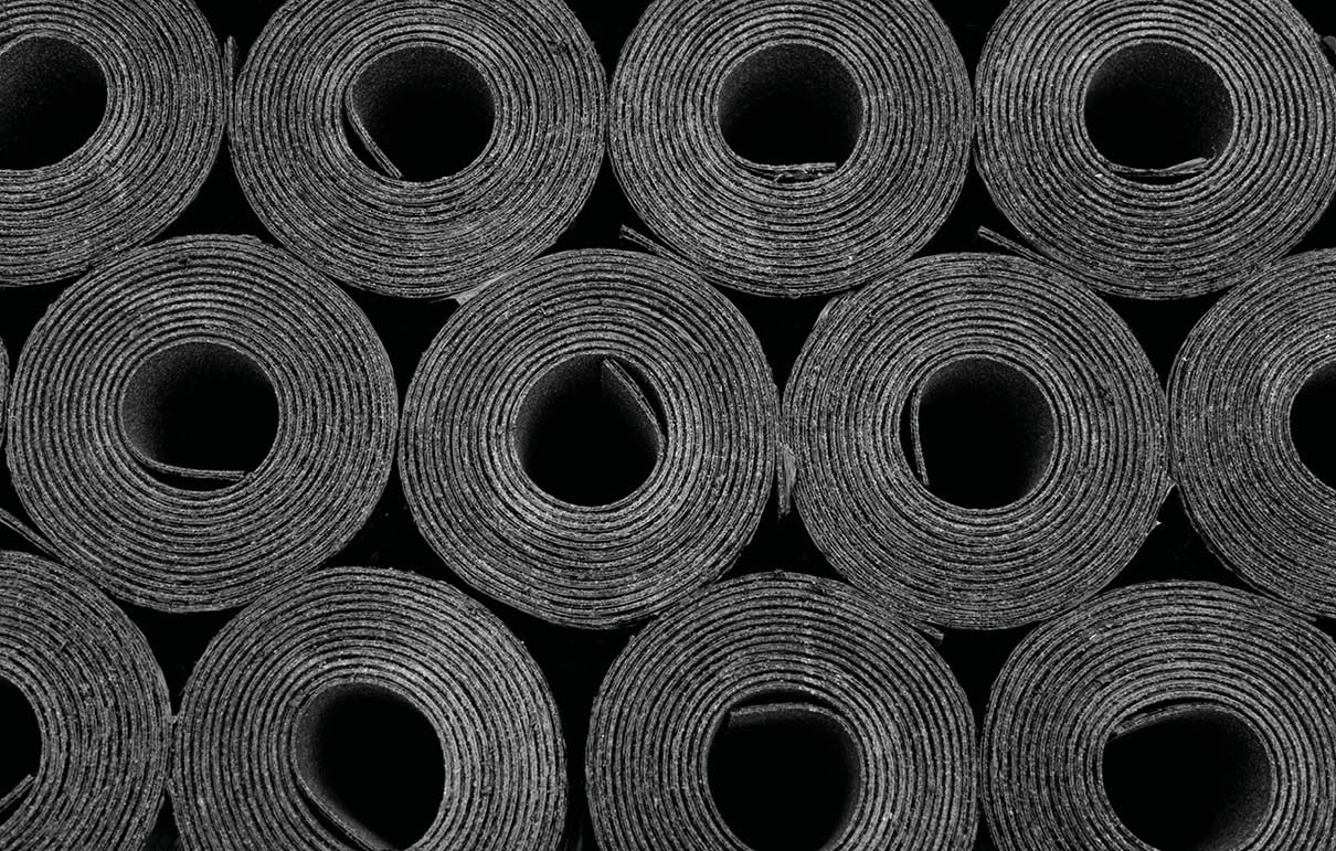 Closeup of Rolls of new black roofing felt or bitumen. Shallow depth off field